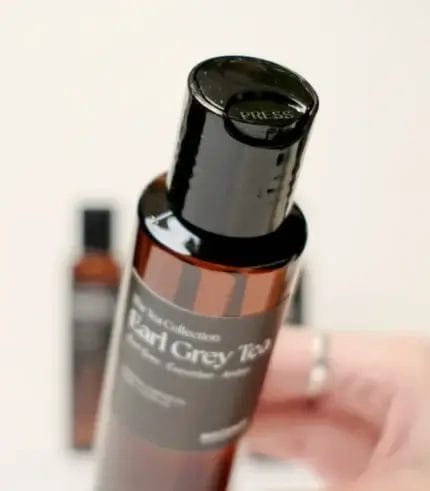 Hand Holding MScents Tea Collection Essential Purifier Oil Bottle Top Shot