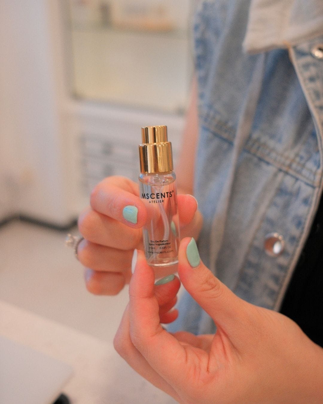 A girl with a mini bottle of her perfume