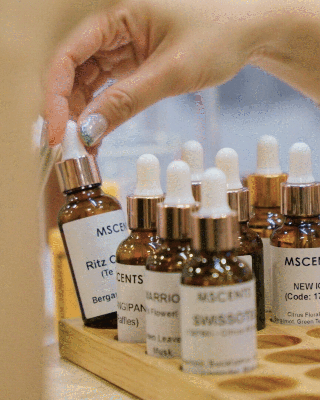 A close-up image of choosing a scent from the rack