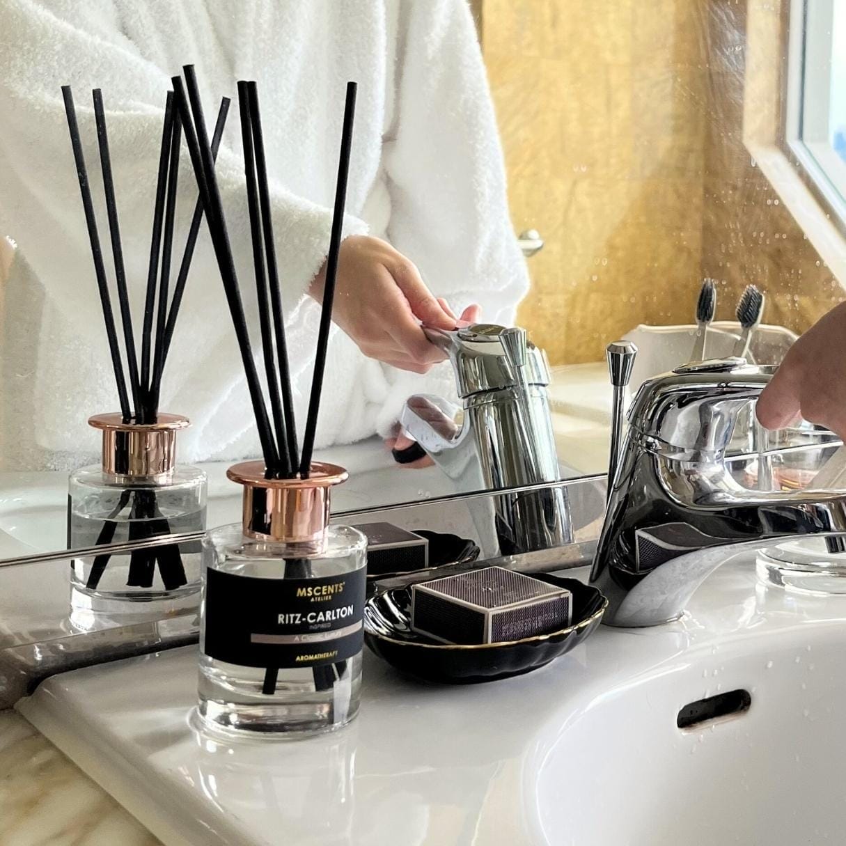 A woman in the hotel bathroom in front of a diffuser